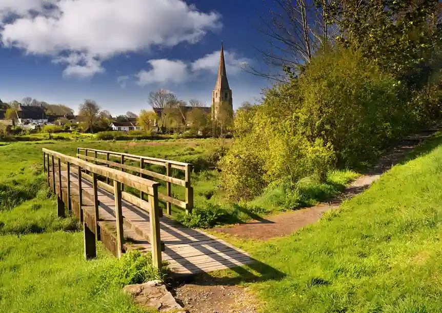 Kidwelly Castle walk with St Mary's Church in the background